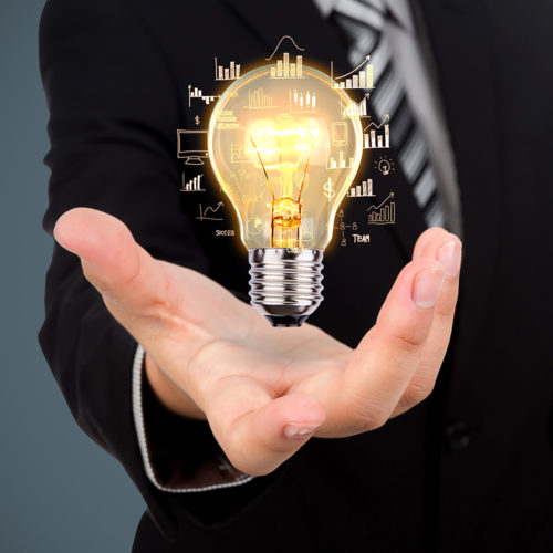 Business man holding light bulb